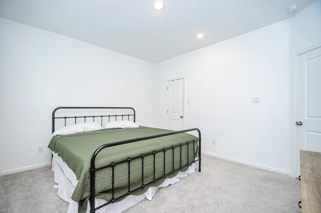 a bedroom with a bed and a dresser