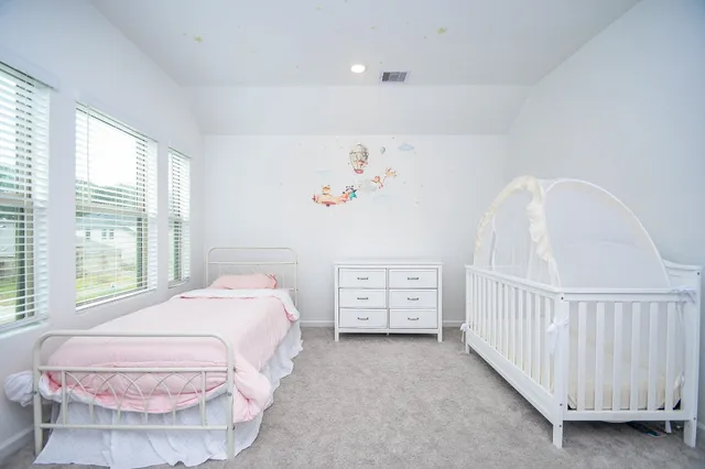 a spacious bedroom with a bed and a window