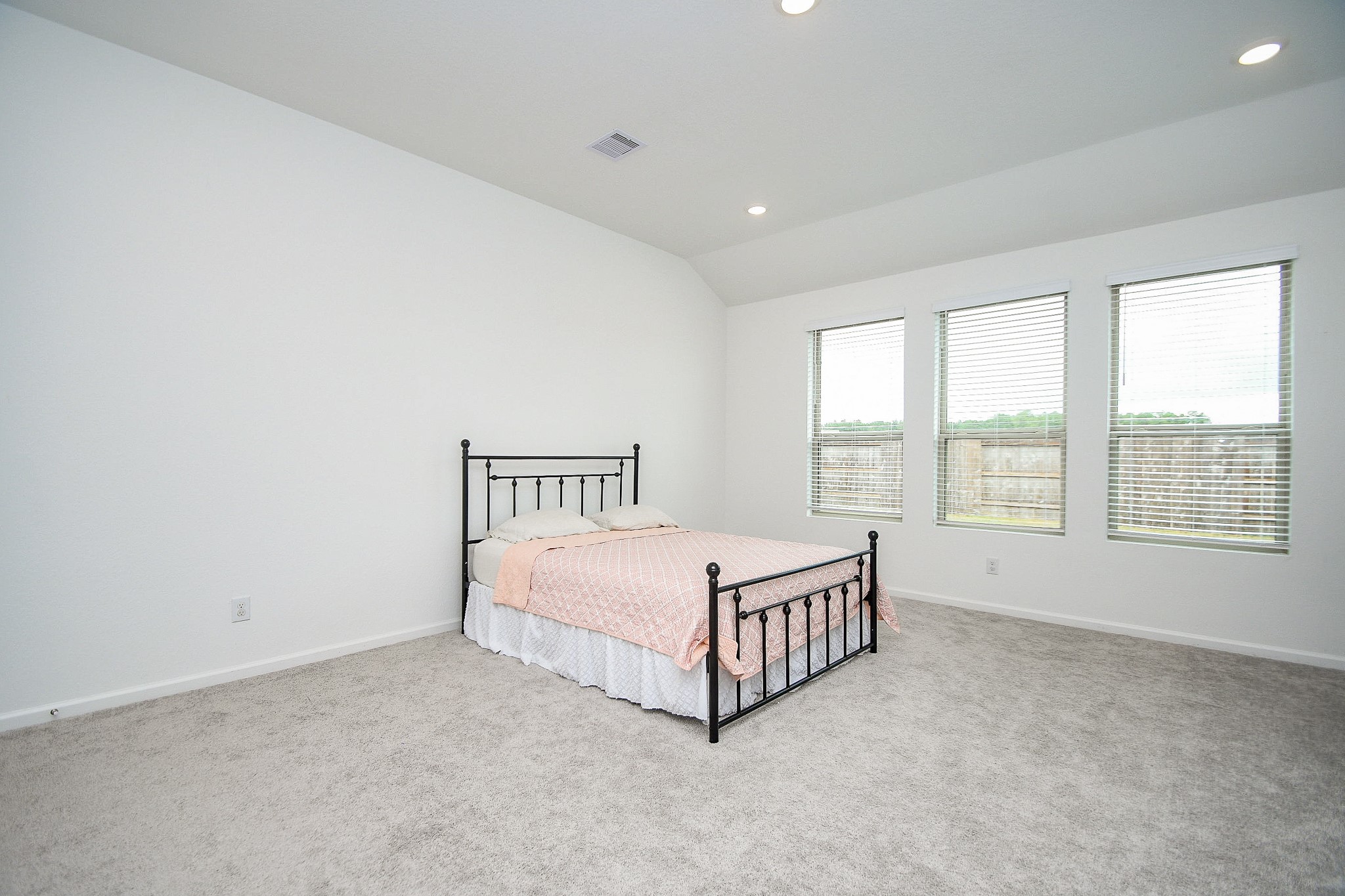 28722 Mount Bonnell Drive New Caney, TX 77357 - Photo 26 of 32 a spacious bedroom with a bed window and a night stand
