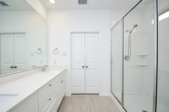 a spacious bathroom with a shower and a sink