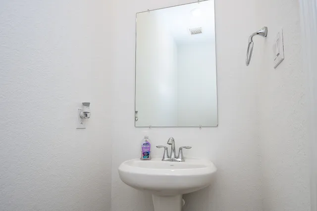a bathroom with a sink a mirror and a toilet