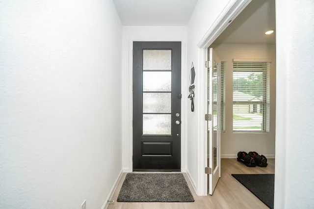 a view of walk in closet with window and entryway