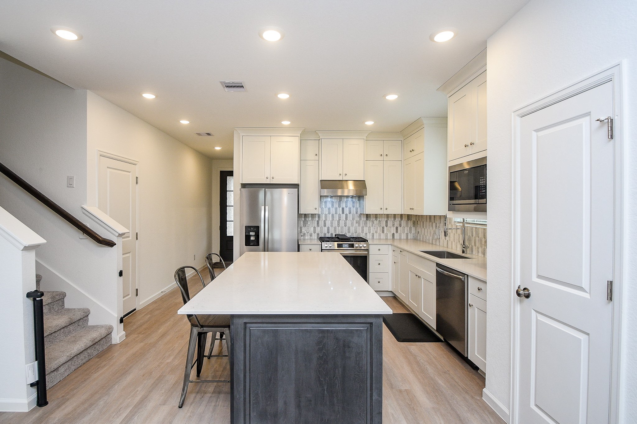 28722 Mount Bonnell Drive New Caney, TX 77357 - Photo 7 of 32 a kitchen with stainless steel appliances a refrigerator and a stove top oven