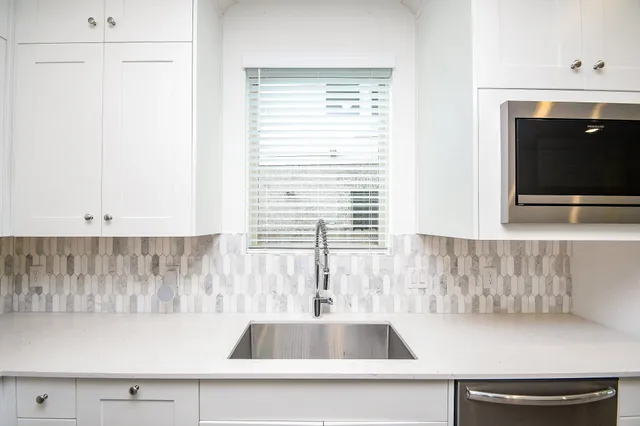a kitchen with a sink and a window