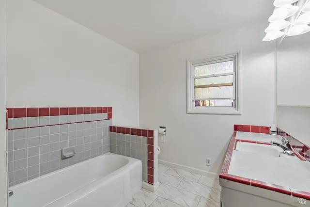 a bathroom with a bathtub sink and vanity