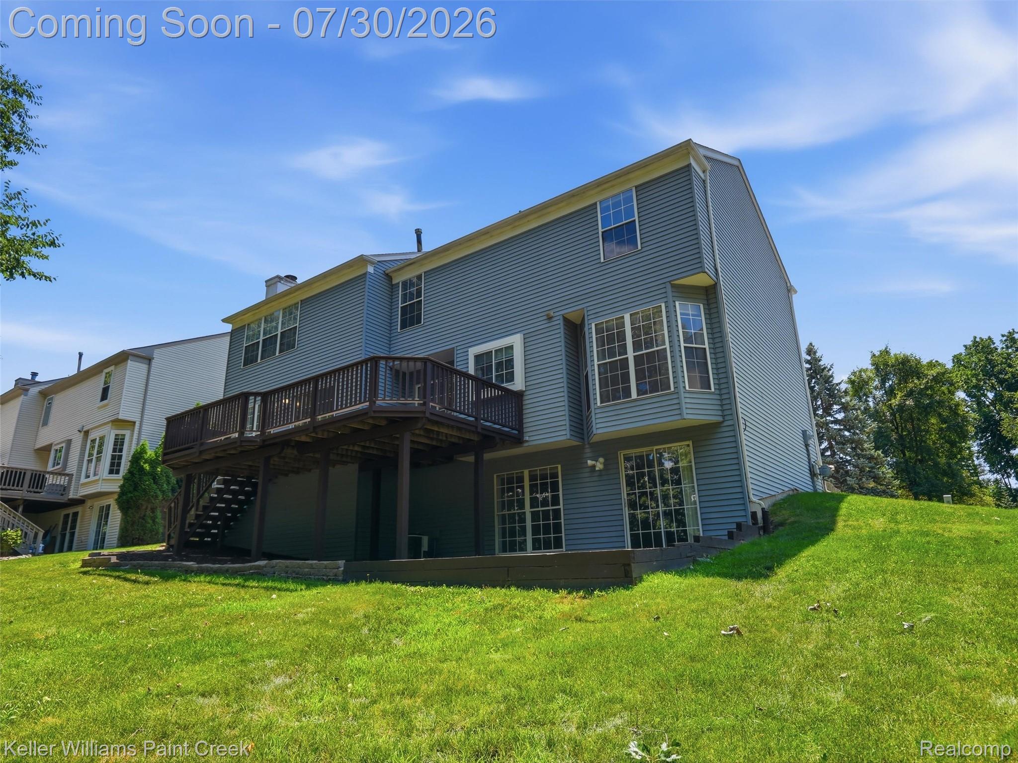 543 Arlington Drive Rochester, MI 48307 - Photo 42 of 59 Rear exterior featuring a multi-level deck with dark wood railing, bay window, and ground-level patio doors
