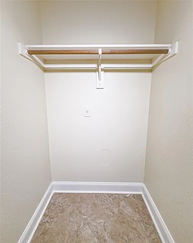 a view of a room with a ceiling fan