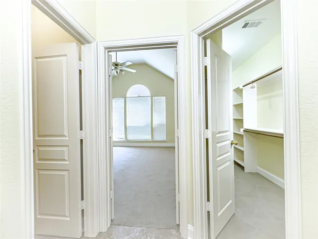 a spacious bathroom with a granite countertop sink a toilet and a mirror