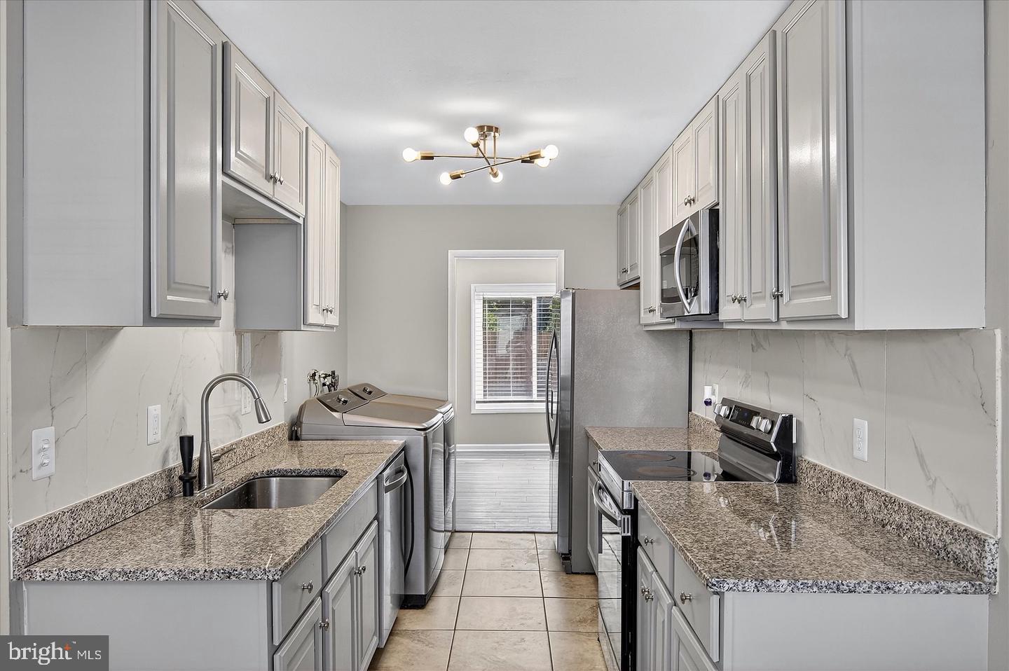 402 Reneau Way Herndon, VA 20170 - Photo 21 of 23 a kitchen with stainless steel appliances granite countertop a sink stove and cabinets