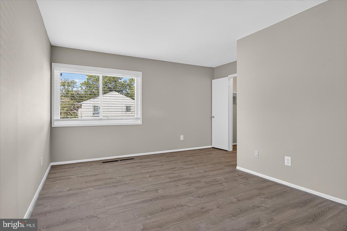 402 Reneau Way Herndon, VA 20170 - Photo 5 of 23 an empty room with wooden floor and windows