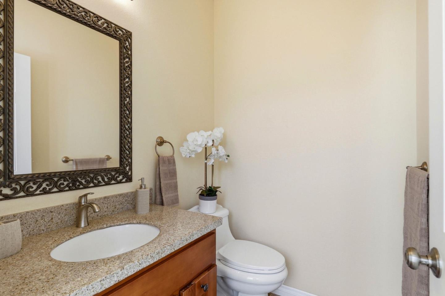 1352 South Stelling Road Cupertino, CA 95014 - Photo 40 of 49 a bathroom with a granite countertop sink and a mirror with toilet