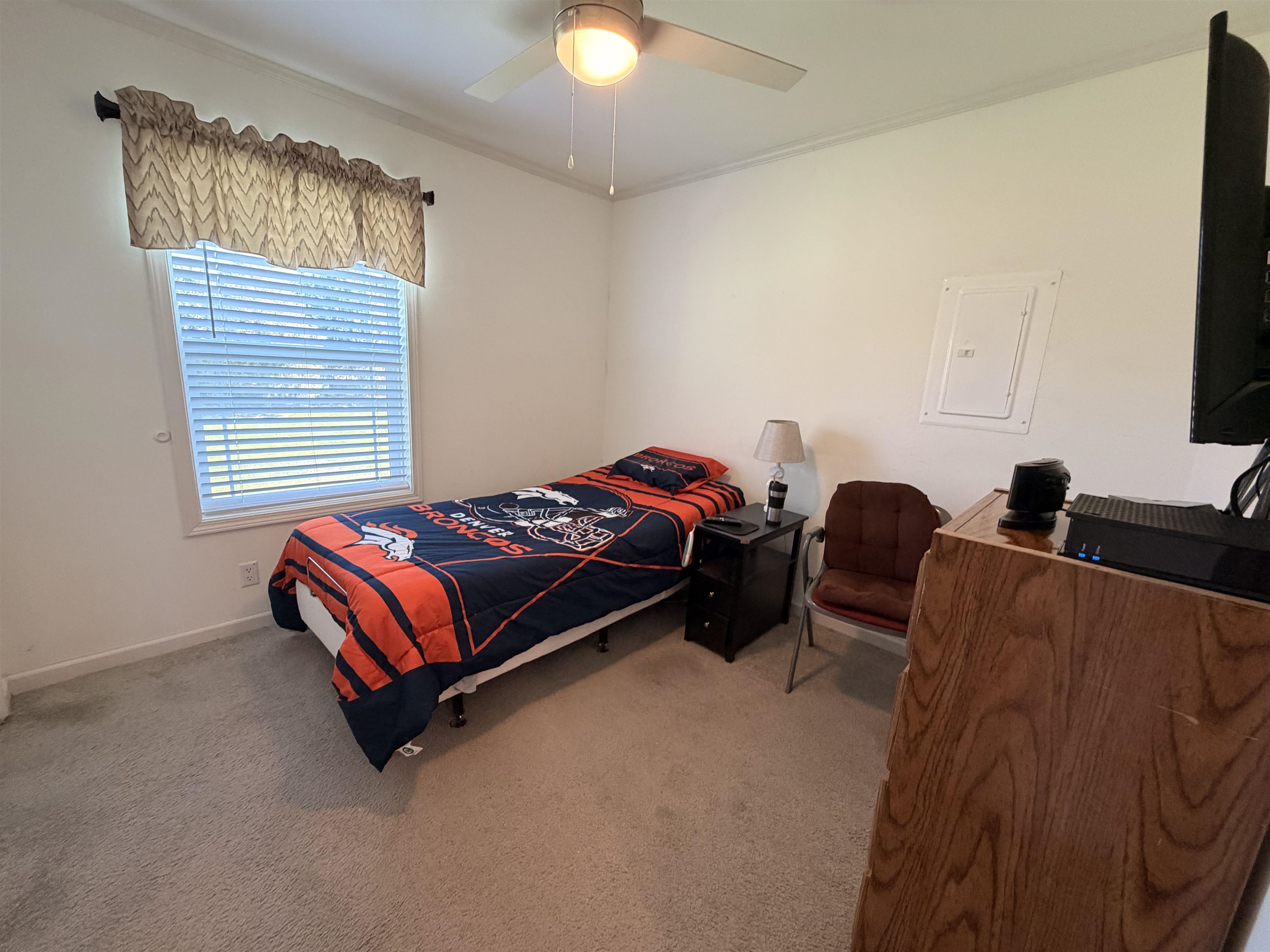 435 32 Road, Unit 826 Clifton, CO 81520 - Photo 9 of 17 a bedroom with a bed and a chandelier