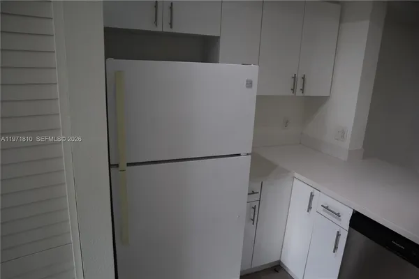 a white refrigerator freezer sitting inside of a kitchen