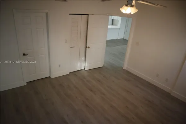 an empty room with wooden floor