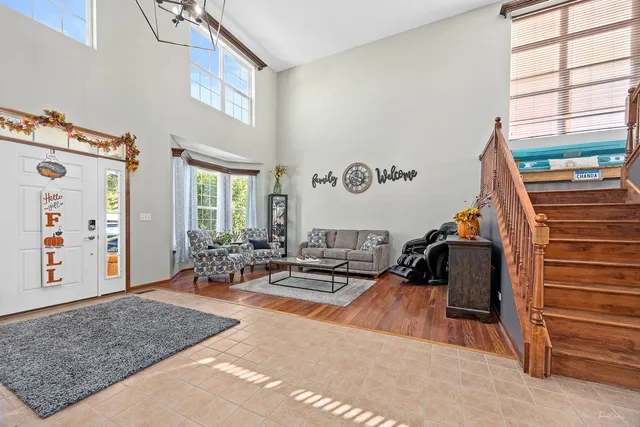 a dining hall with stainless steel appliances granite countertop a stove a sink a dining table and chairs with wooden floor