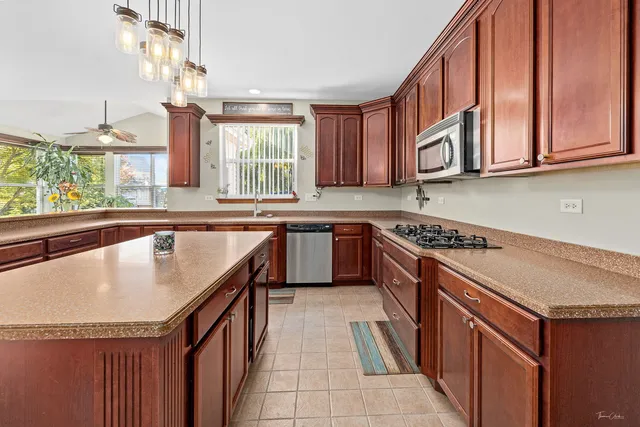 a bedroom with a bed window and dresser