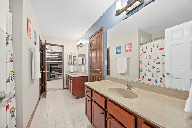 a bedroom with a large bed and a flat screen tv