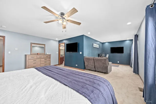 a large white bathroom with a granite countertop double vanity sink a mirror and a bathtub