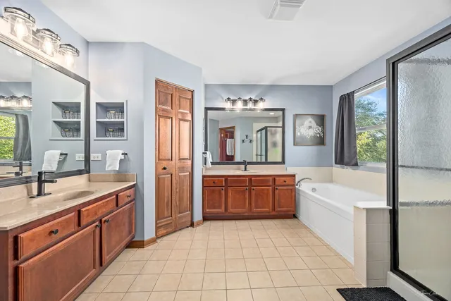 a kitchen with a refrigerator sink and cabinets