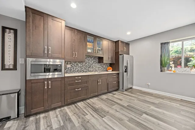 a bathroom with a granite countertop toilet sink and mirror