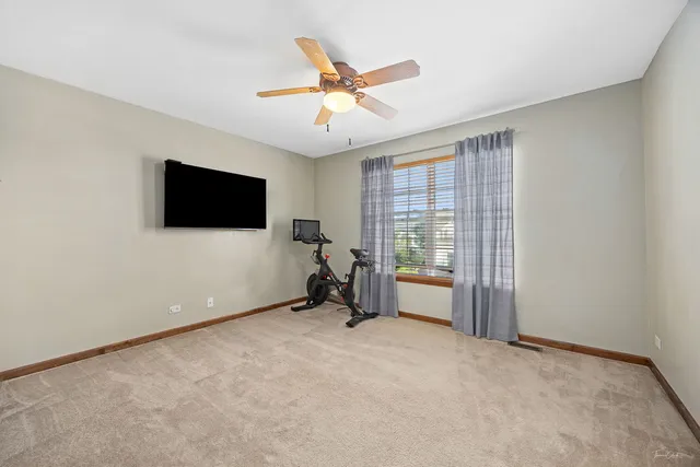 a large bathroom with a glass shower door and a sink