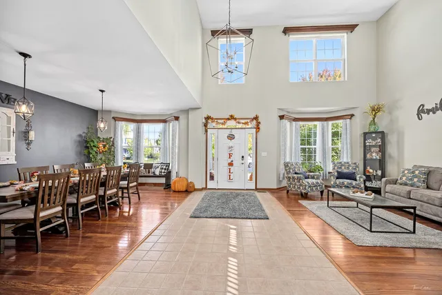 a living room with furniture dining table and a large window
