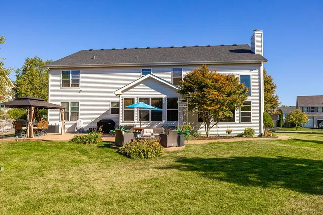 a view of a patio with table and chairs potted plants with wooden fence