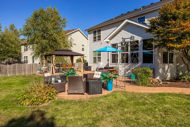 a view of a white house with a yard and plants