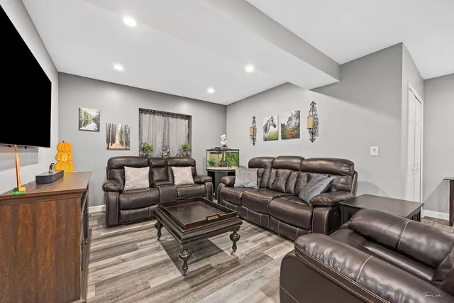 a living room with furniture and wooden floor