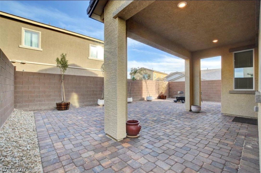 6920 Fossil Rim Street North Las Vegas, NV 89084 - Photo 8 of 9 A private outdoor space features a spacious paver patio and covered area, ideal for relaxed entertaining.