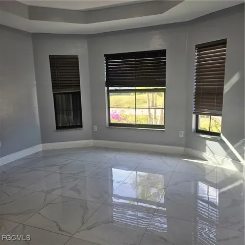 a view of an empty room with windows