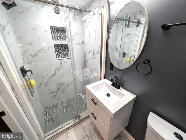 a bathroom with a sink mirror and vanity