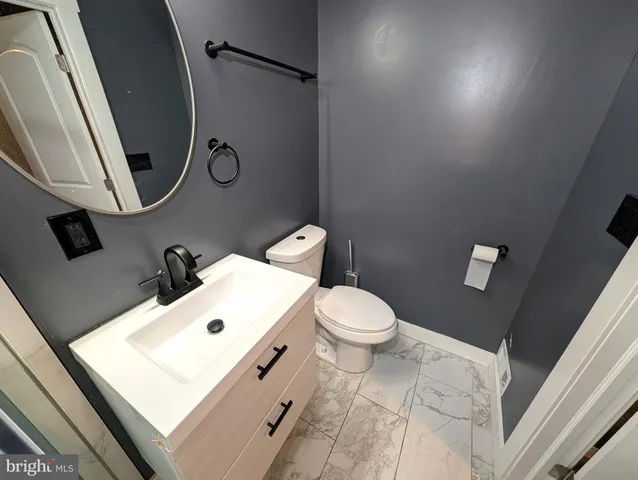 a white toilet sitting next to a bathroom sink