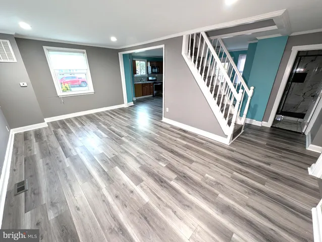 a view of an entryway with wooden floor