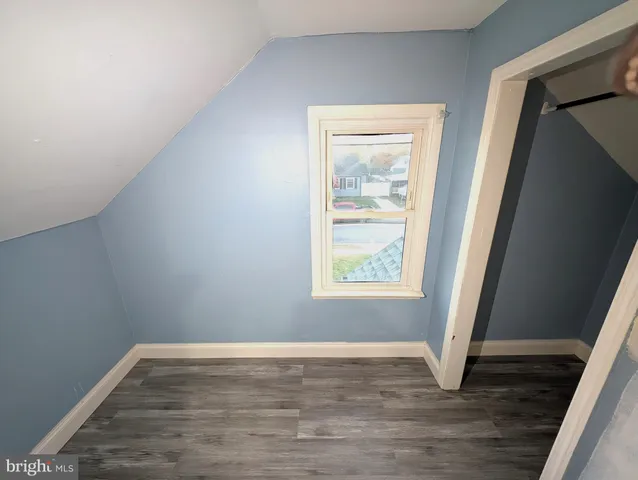 a view of a small house with wooden fence