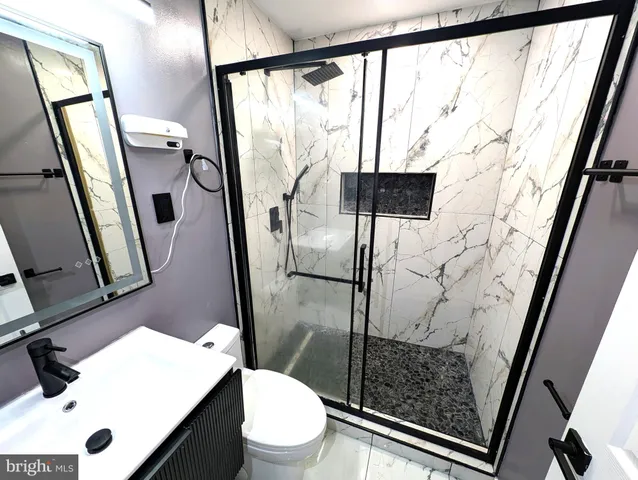 a bathroom with a toilet and a shower