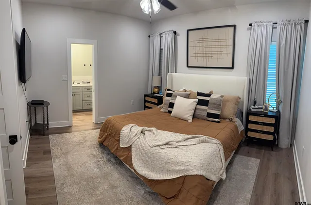 a bedroom with bed and a night stand