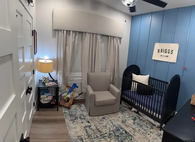 a living room with furniture and a lamp