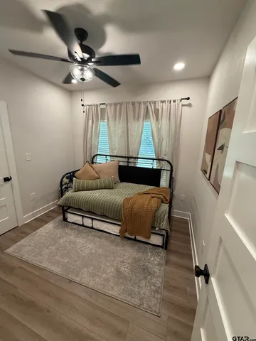 a living room with furniture and a ceiling fan