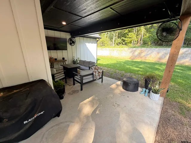 a living room with patio furniture and a floor to ceiling window