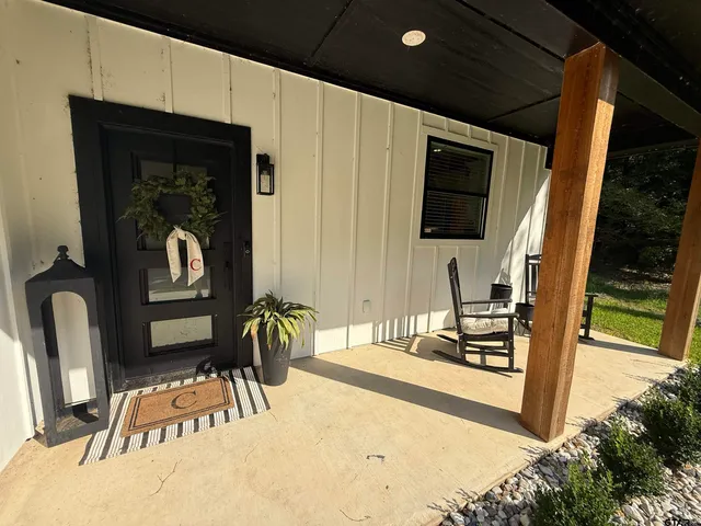 a view of a livingroom with furniture and the floor to ceiling window