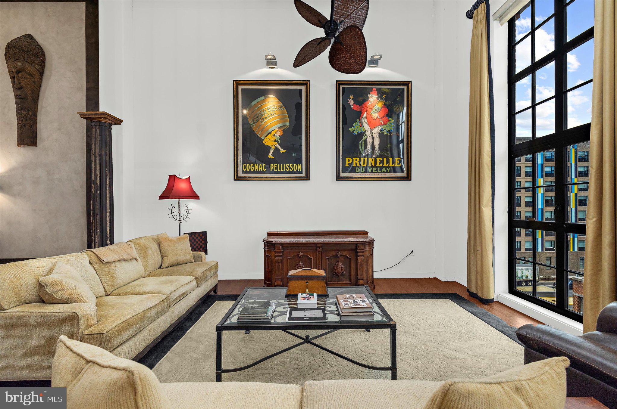 1220 Bank Street, Unit 409 Baltimore, MD 21202 - Photo 11 of 53 a living room with furniture a rug and wall paintings