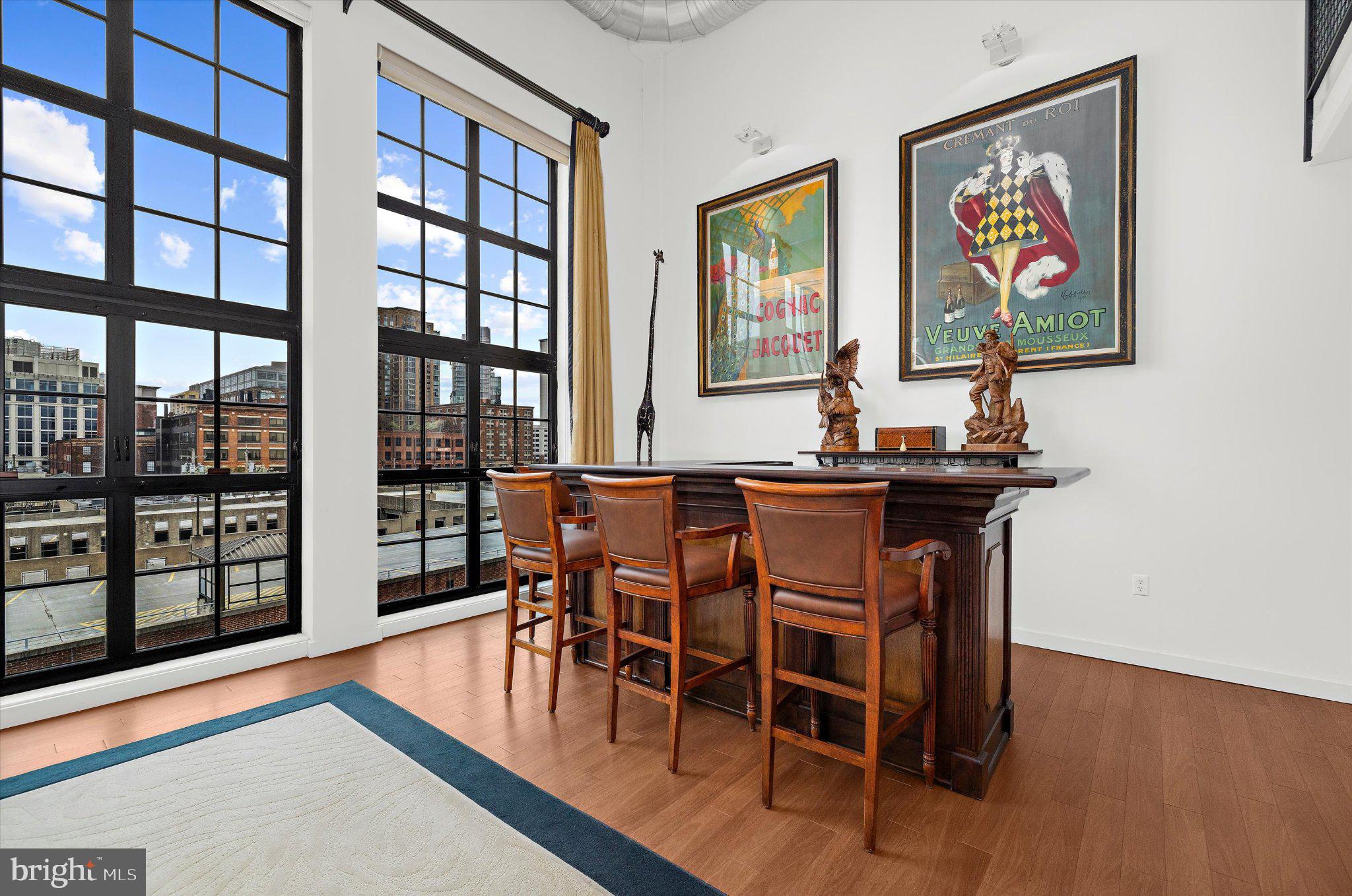 1220 Bank Street, Unit 409 Baltimore, MD 21202 - Photo 25 of 53 a view of a dining room with furniture window and wooden floor