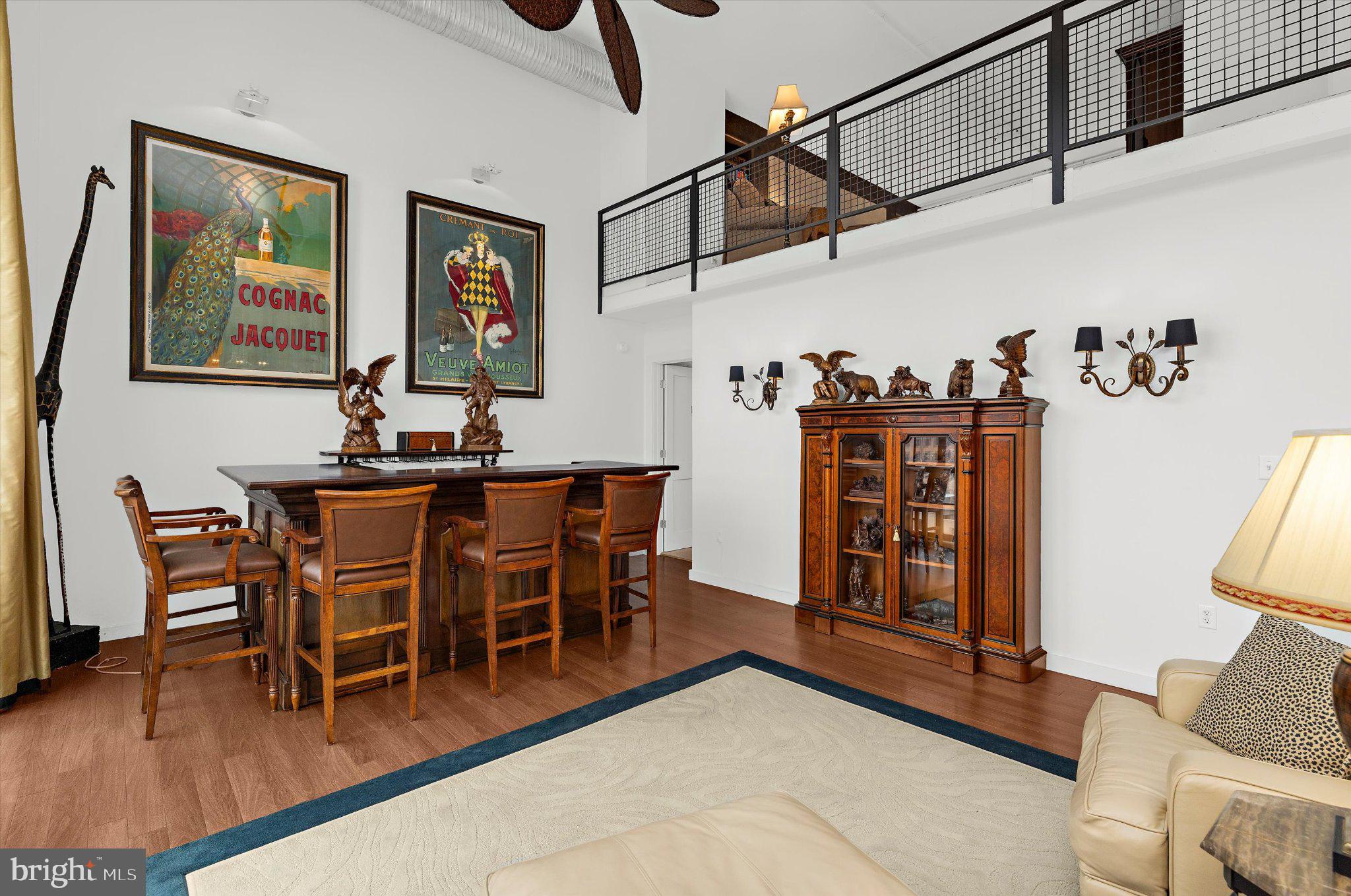 1220 Bank Street, Unit 409 Baltimore, MD 21202 - Photo 26 of 53 a view of a dining room with furniture wooden floor and a chandelier