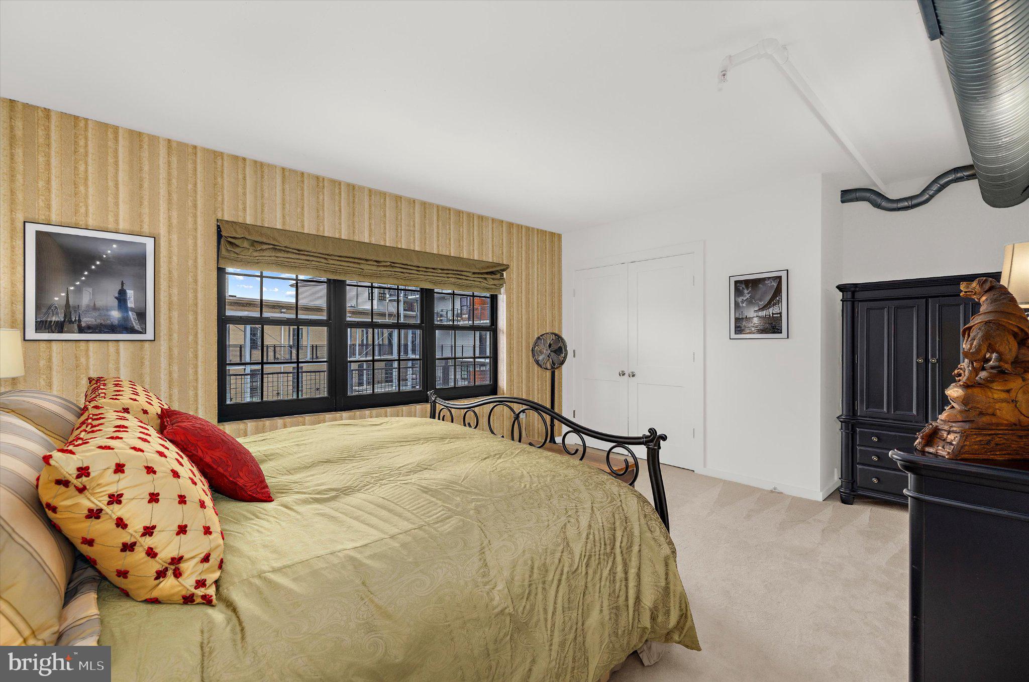 1220 Bank Street, Unit 409 Baltimore, MD 21202 - Photo 30 of 53 a bedroom with a bed and a window