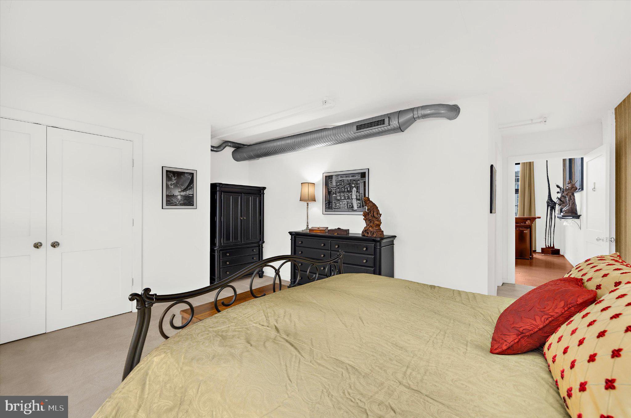 1220 Bank Street, Unit 409 Baltimore, MD 21202 - Photo 31 of 53 a bedroom with a bed and a table in it