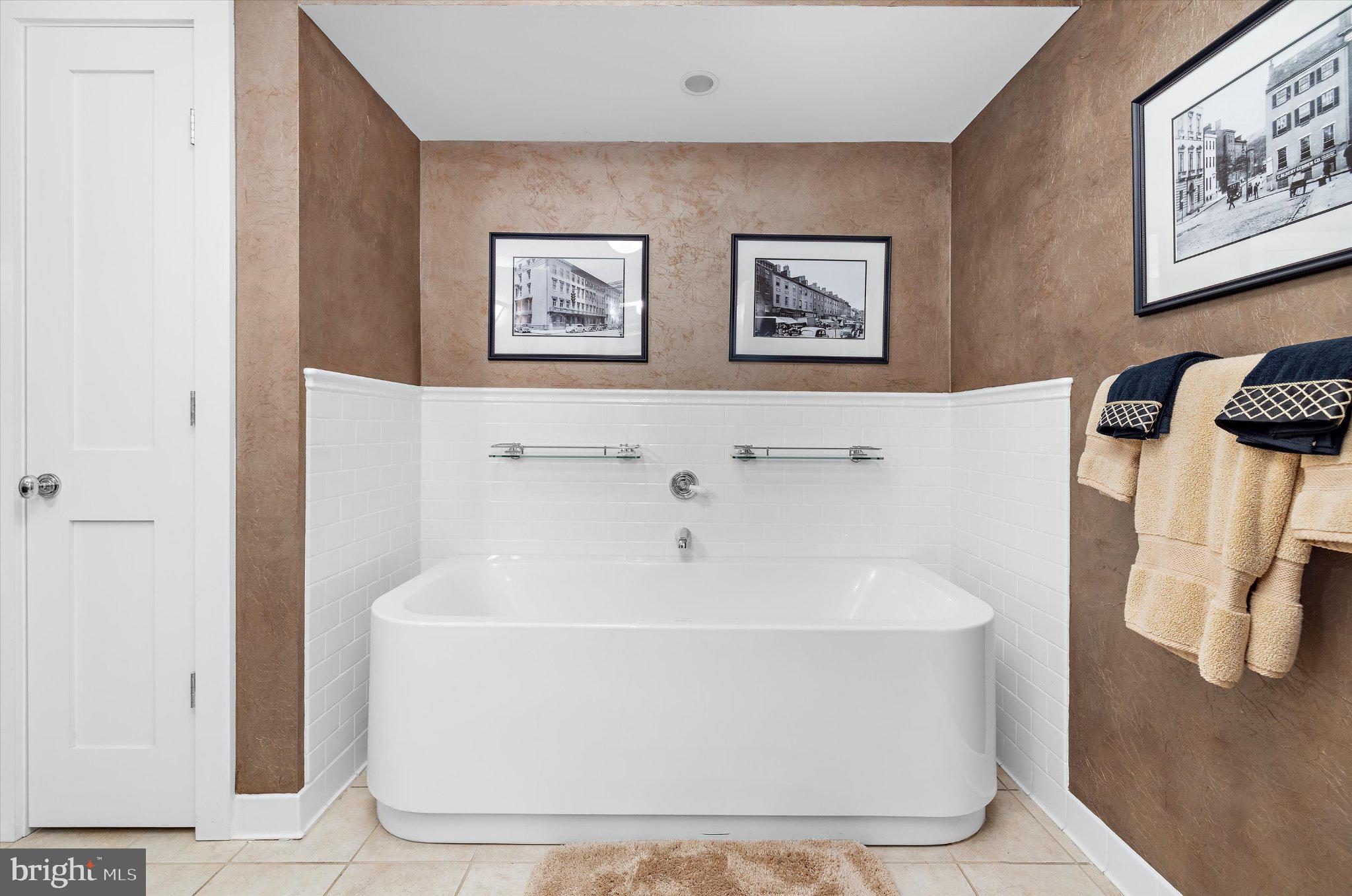 1220 Bank Street, Unit 409 Baltimore, MD 21202 - Photo 41 of 53 a white bath tub sitting in a bathroom