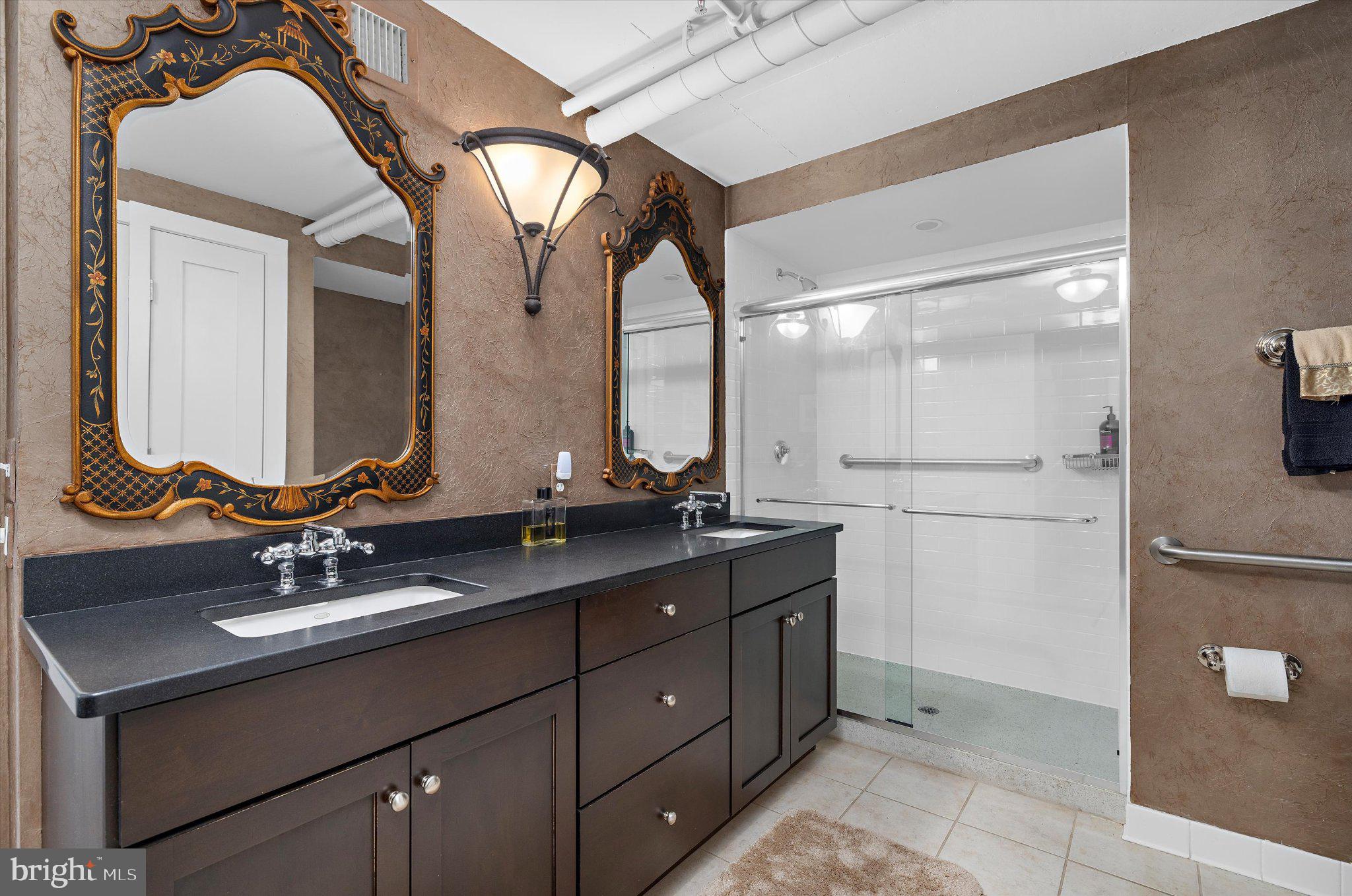 1220 Bank Street, Unit 409 Baltimore, MD 21202 - Photo 42 of 53 a bathroom with a double vanity sink and mirror