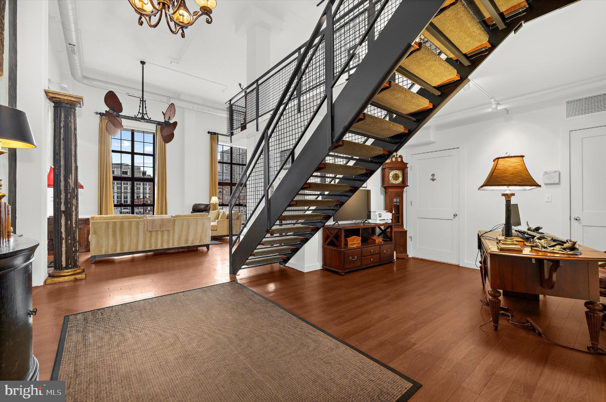 1220 Bank Street, Unit 409 Baltimore, MD 21202 - Photo 6 of 53 a view of a livingroom with furniture and staircase