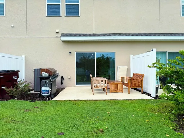 a view of an house with backyard porch and furniture